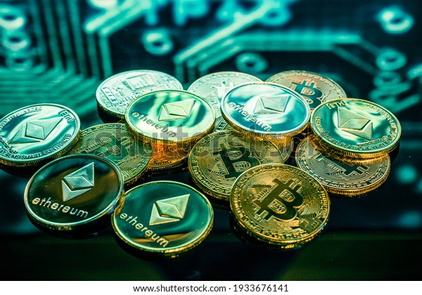 Bitcoin gold,\
silver and copper coins and defocused printed circuit background.\
Virtual cryptocurrency\
concept.