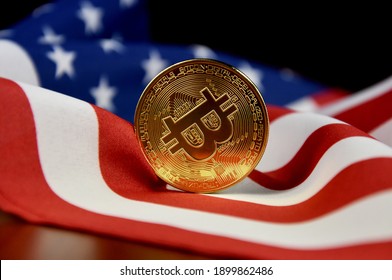 Bitcoin golden coin on american flag stock images. Cryptocurrency with american flag images. Digital gold images. Beautiful gold bitcoin coin photo images