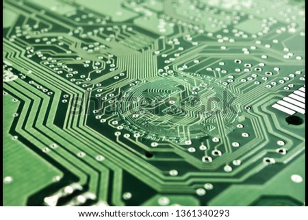 Bitcoin integrated in a green a printed circuit board (PCB). Connected to the internet processing transactions and changing the world economy. Stock photo © 