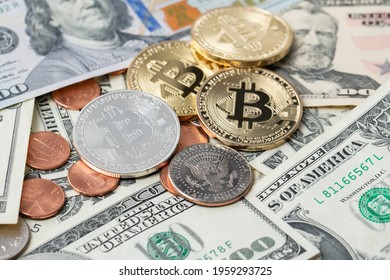 Bitcoin next to dollar coins and banknotes. Digital crypto currency with USD cash. Exchanging dollar with crypto currencies over block chain technology concept.