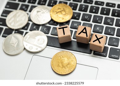 Bitcoin and next to wooden with TAX letters. Bitcoin taxation concept - Shutterstock ID 2338225579