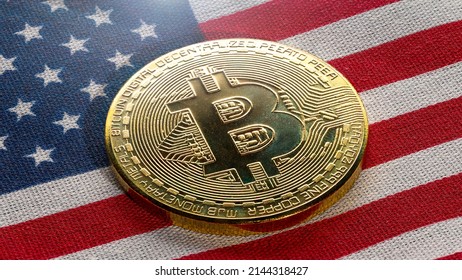 Bitcoin on American flag. Bitcoin BTC Cryptocurrency Coins. Stock Market Concept. BTC to USD Real crypto metal golden coin. United States of America. High quality macro photo good for billboard.
