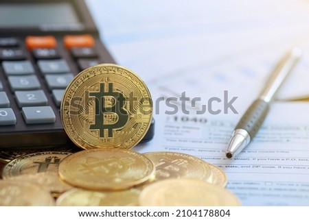 Bitcoin on a calculator and individual income tax return form 1040. tax for the trading of crypto-currencies.The time to pay taxes concept.
