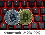 Bitcoin on compuer keyboard in background, symbol of electronic virtual money and mining cryptocurrency concept. Coin crypto currency bitcoin lies on the keyboard. Bitcoin on keyboard.