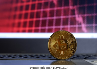bitcoin on laptop computer in front of red background - Shutterstock ID 1169619607