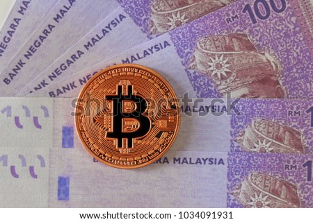 Bitcoin On Malaysia Ringgit Banknotes Background S!   tock Photo Edit - 