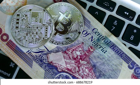 Bitcoin on Nigerian Naira banknote. Electronic money exchange concept
