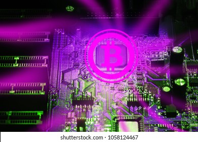 Bitcoin on the pink background of the electronic circuit of the PC motherboard. Abstract concept of digital currency.