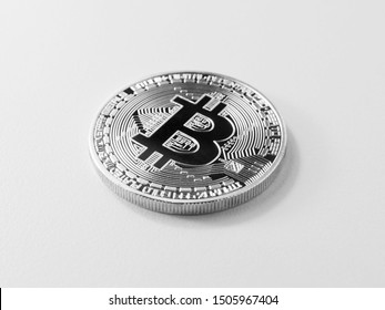 Bitcoin real coin made of steel on the surface, closeup, isolated on white background