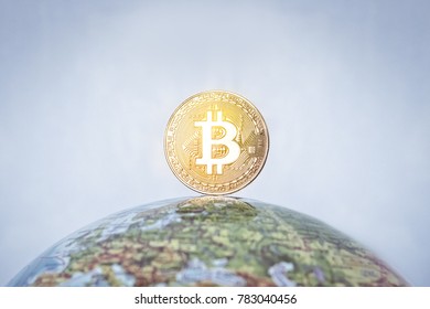 BITCOIN Tag On The Globe. Gold Bitcoin With Gold Bitcoin Symbol And Earth. Bitcoin As A Symbol World Currency. Globalization, Globalize, Worldwide, Universal, Global, International,