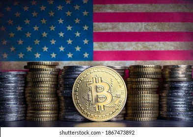 Bitcoin Token Infront Of Currency Coins And Grungy Flag Of The United States.