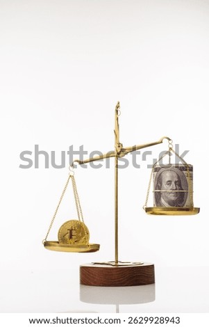 Bitcoin value increase trend. The coin outweighs the balance. On another bowl a stack of hundred dollar bills.