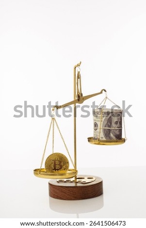 Bitcoin value increase trend. The coin outweighs the balance. On another bowl a stack of hundred dollar bills. White background - image