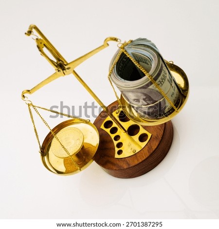 Bitcoin value increase trend. The coin outweighs the balance. On another bowl a stack of hundred dollar bills. White background - image