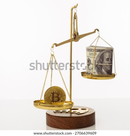 Bitcoin value increase trend. The coin outweighs the balance. On another bowl a stack of hundred dollar bills. White background - image