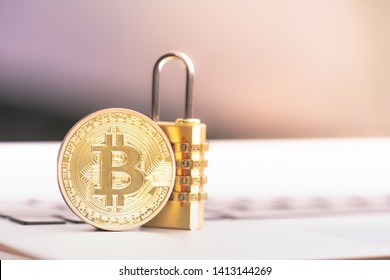 Bitcoin(BTC) coin with padlock lying on computer background. Bitcoin security. digital cyber safety or security encryption, Blockchain technology to encode online information or data protection. 