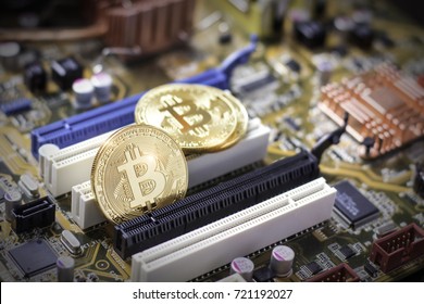 Bitcoins on the computer motherboard. Mining cryptocurrency concept - Shutterstock ID 721192027