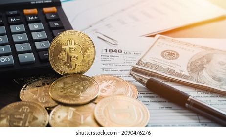 Bitcoins with US tax form 1040. Golden Bitcoin on tax form whit US money Calculator and pan. 2022 Tax form pay concept. 