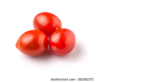 Bite sized red cherry grape tomato over white background