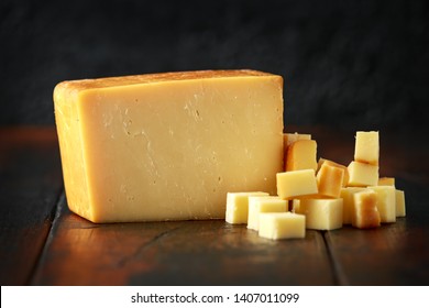 Bitesize Sliced Smoked Cheddar Cheese On Rustic Wooden Background