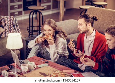 Biting Piece. Beautiful Teenage Girl Biting Piece Of Salami Pizza Having Lunch With Her Friends