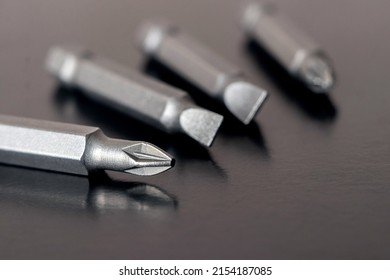 Bits, nozzles for tightening screws on a dark brown background