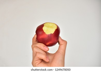 bitten apple and hand - Powered by Shutterstock