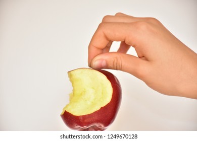 bitten apple and hand