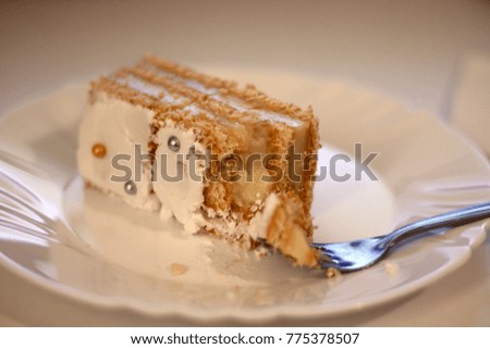Bitten cake on plate with fork.