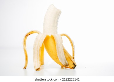 Bitten ripe banana, isolated on white background