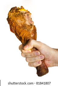 Bitten Turkey Leg On Male Hand Over White