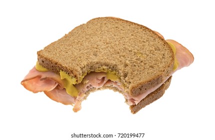 Bitten Virginia Ham Sandwich On Wheat Bread With Mustard Isolated On A White Background.