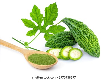 Bitter gourd or bitter melon with green herbal powder in wooden spoon isolated on white background. 