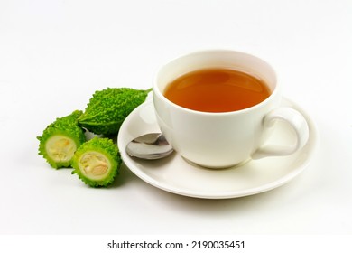Bitter Gourd Or Bitter Melon Tea In Ceramic Cup Isolated On White Background. Scientific Name Is Momordica Charantia. As A Whole Food And Herbs For Treating Diseases.