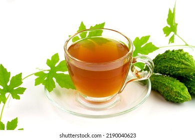 Bitter Gourd Or Bitter Melon Tea In Transparent Cup And Fresh Bitter Gourd With Green Leaf Isolated On White Background. Scientific Name Is Momordica Charantia. As A Whole Food And Herbs For Treating 