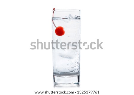 Bitter transparent cocktail with cocktail cherry isolated on white background. Selective focus. Shallow depth of field.
