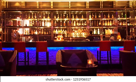 Bitters And Infusions On Bar Counter With Blurred Bottles In Background.
