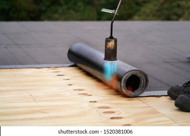 Bitumen Roofing.  A With A Gas Burner And A Roll Of Tar Paper. Flat Roof Installation.