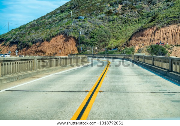 Bixby Bridge\
road in California, view from a\
car.