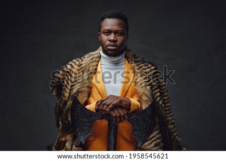 Bizarre african man with axe and fur