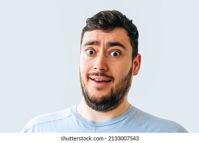 bizarre and strange bearded man. male face grimace looking at camera. - Shutterstock ID 2133007543