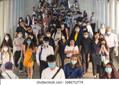 BKK THAILAND, 16 Mar 2020 :Group of many salary man wearing face mask for protect coronavirus in air while going to their workplace during coronavirus outbreak crisis in Bangkok at morning rush hour.