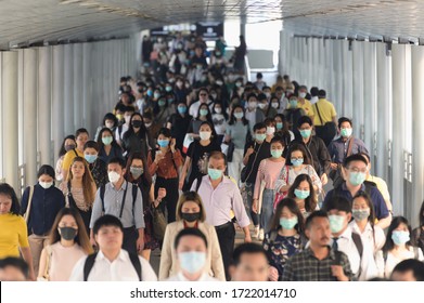 BKK THAILAND, 16 Mar 2020 :Group of many salary man wearing face mask for protect coronavirus in air while going to their workplace during coronavirus outbreak crisis in Bangkok at moring rush hour.