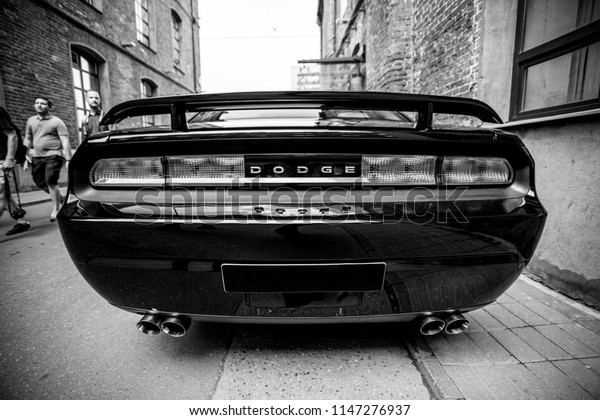 Black\
2009 Dodge Challenger on the city street. Back view. Black and\
white photography. July 29, 2018, Moscow,\
Russia.