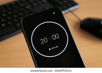 Black 20-minute timer in phone to study or be productive. Student time planning studying, homework, office productivity.