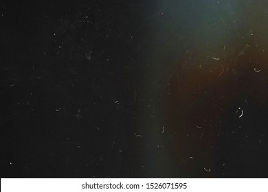 Black abstract background. The effect of the old film photography. 90s. Lens flare. Heavy grain texture