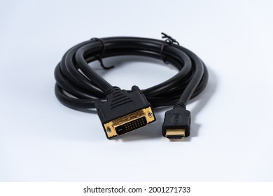 Black adapter cable from DVI plug to HDMI plug isolated on white background.
