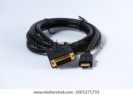 Black adapter cable from DVI plug to HDMI plug isolated on white background.