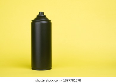 Black Aerosol Can On A Yellow Background.