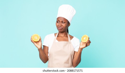 Black African American Adult Chef Woman . Orange Juice Concept